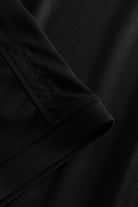 Black golf polo shirt with WHAT BUNKERS details. 